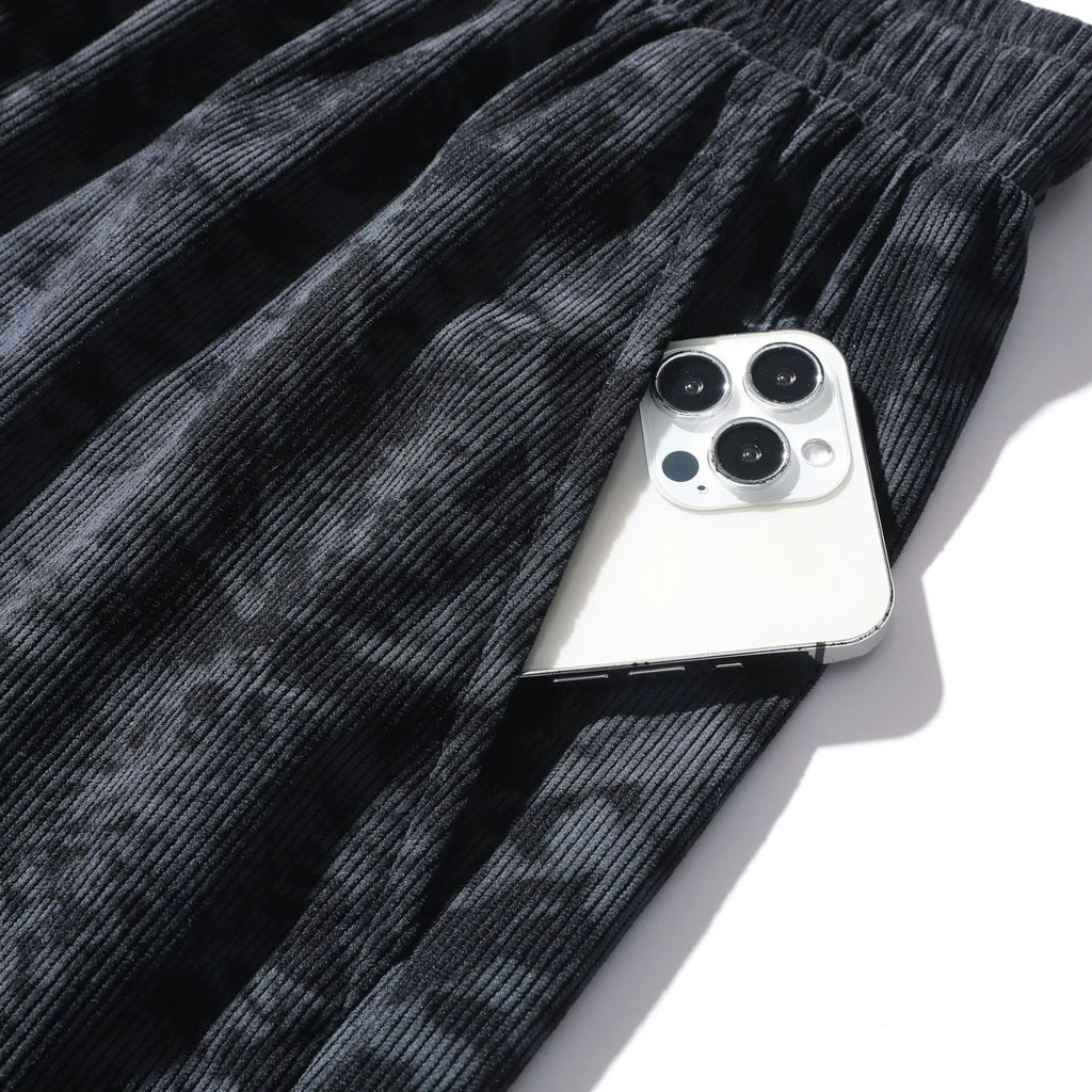 Men's camouflage patterned corduroy shorts with elastic high waistband in straight leg cut.
