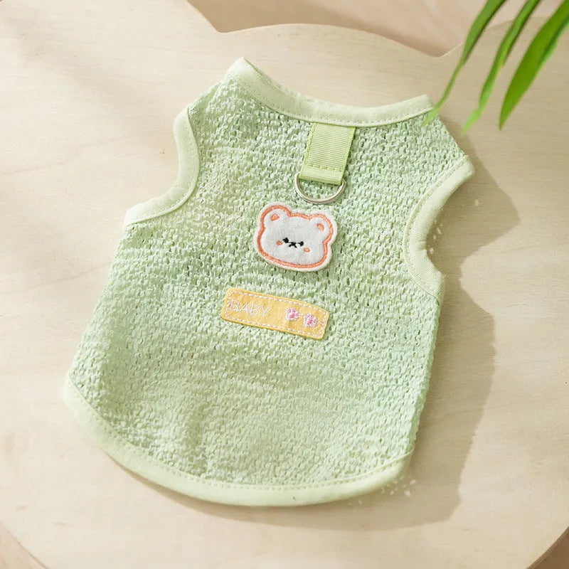 Green knitted cat clothing with a bear patch, showing hollowed-out breathable fabric.