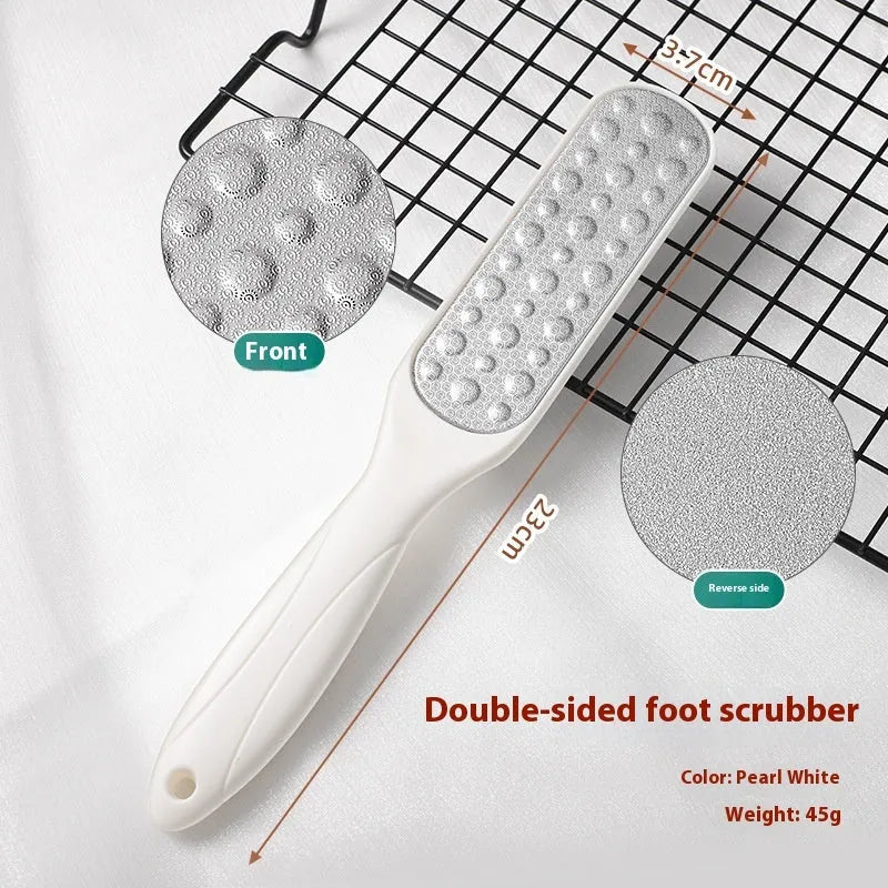 Double-sided stainless steel foot grinder with black and white grit attachments for callus removal
