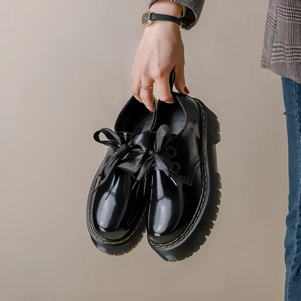 Women's thick soled leather shoes with cross straps and ribbons in black or white colours