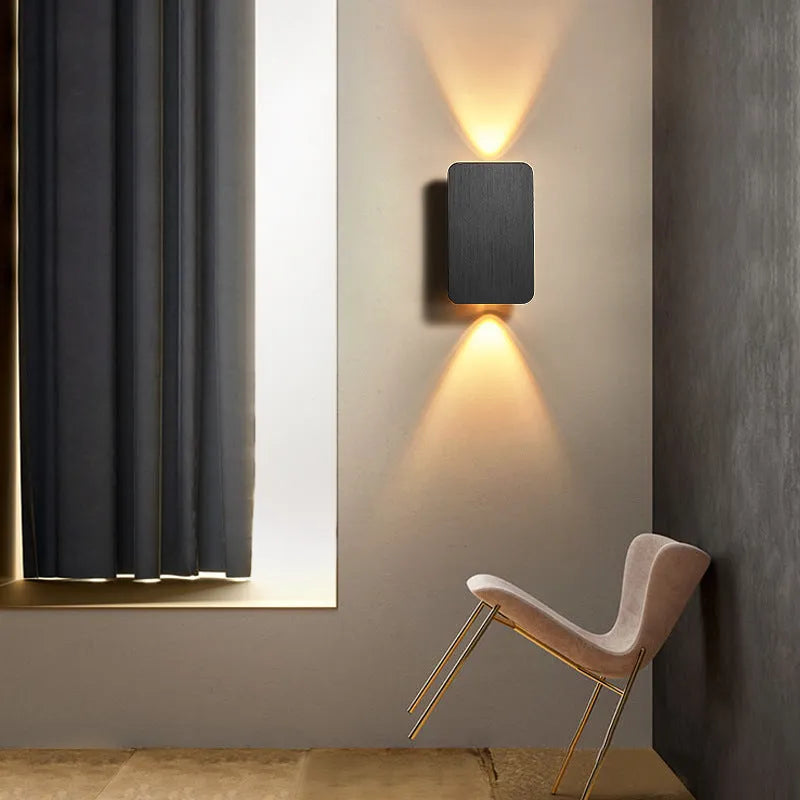 Modern Nordic minimalist LED wall lamp mounted beside bed showing black finish and warm light illumination