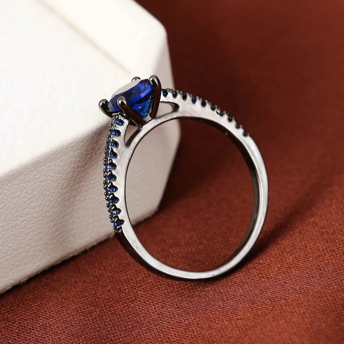 Hexagonal geometric zircon ring in copper with electroplated finish showing angular design and zircon stone