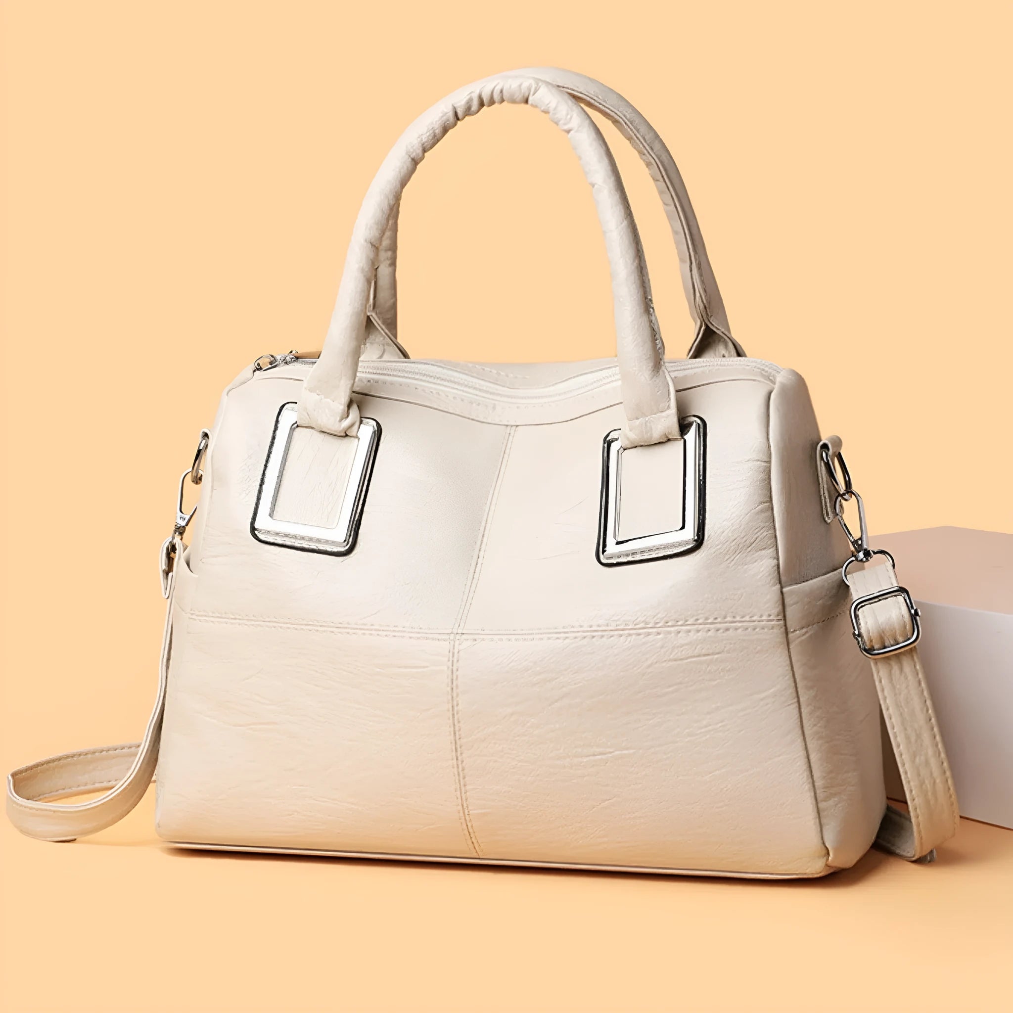 Simple large capacity women's shoulder bag in a square shape, shown in a neutral colour with visible structure.