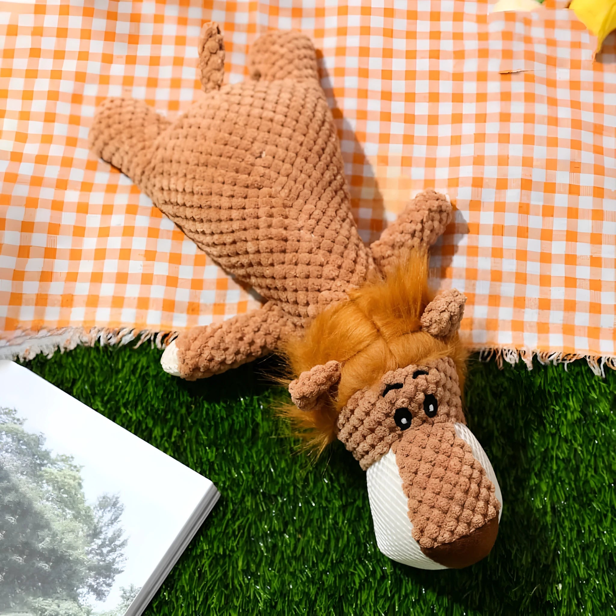 Grey plush dog toy shaped and textured like an ear of corn with visible kernels, lying on a plain surface.