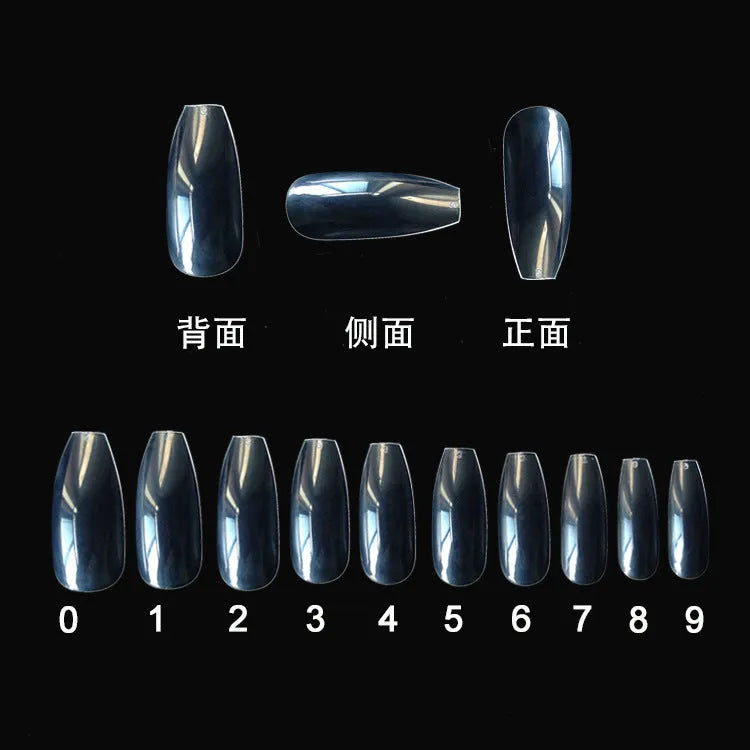 500 clear acrylic false nails in various sizes spread out on a table