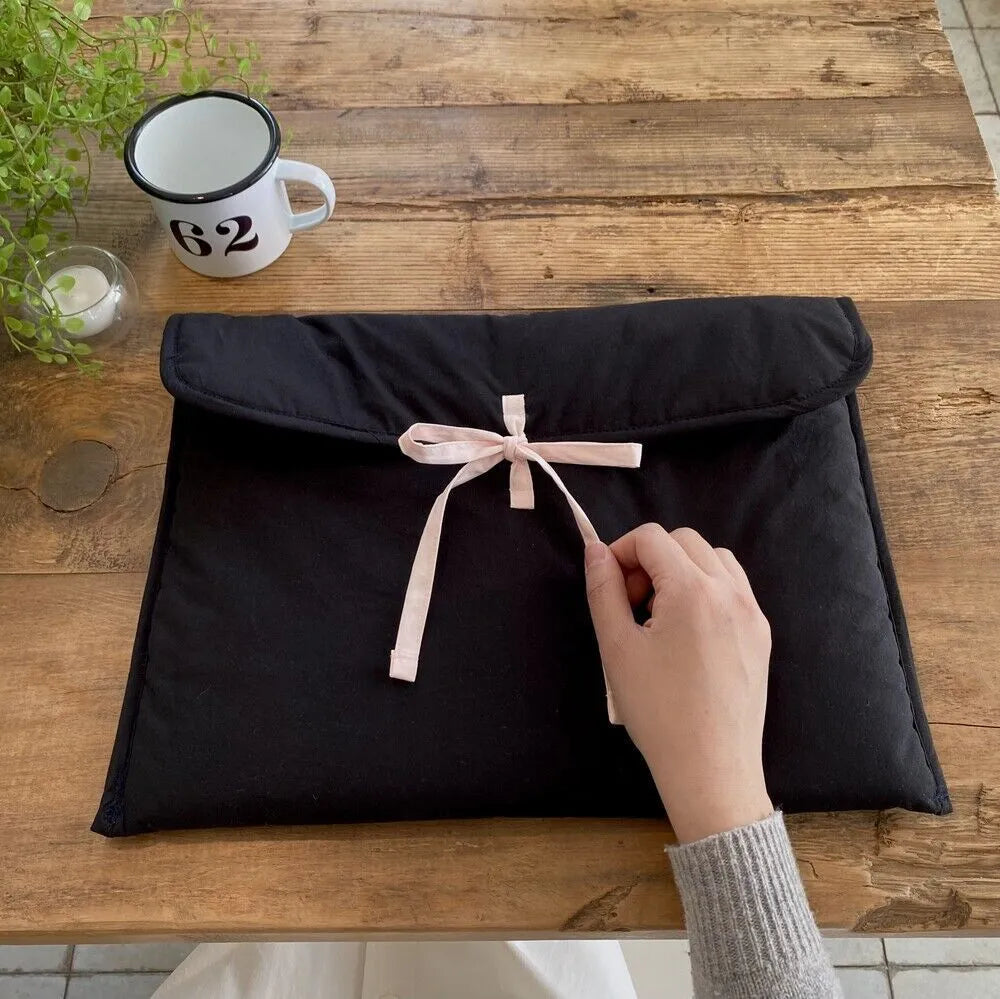 Women's black and white striped ballet bow quilted computer bag showing nylon material