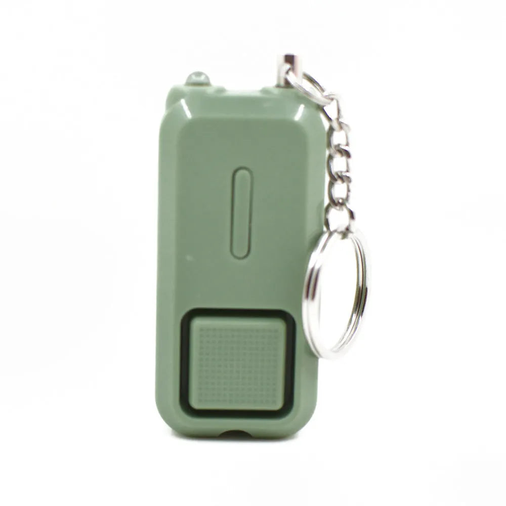 Pink personal security alarm showing compact size next to LR44 batteries