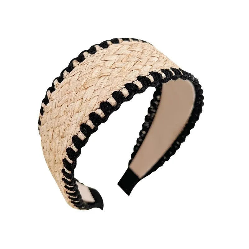 Bamboo woven wide brim hair band in black with bend and hitch details, side view on plain background