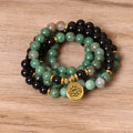 Green and black alloy elastic beaded bracelet on a wrist.