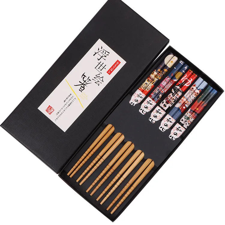 Set of five pairs of bamboo chopsticks with Japanese cartoon patterns in a gift box.