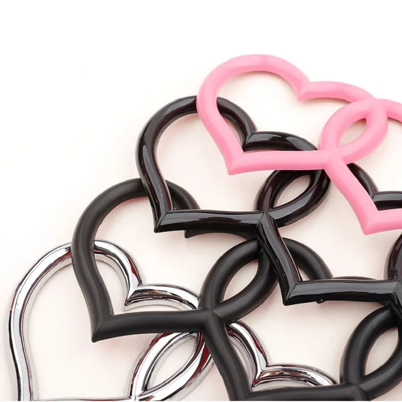 Heart-shaped body sticker with four-ring tail design in electroplated silver colour on a car bumper