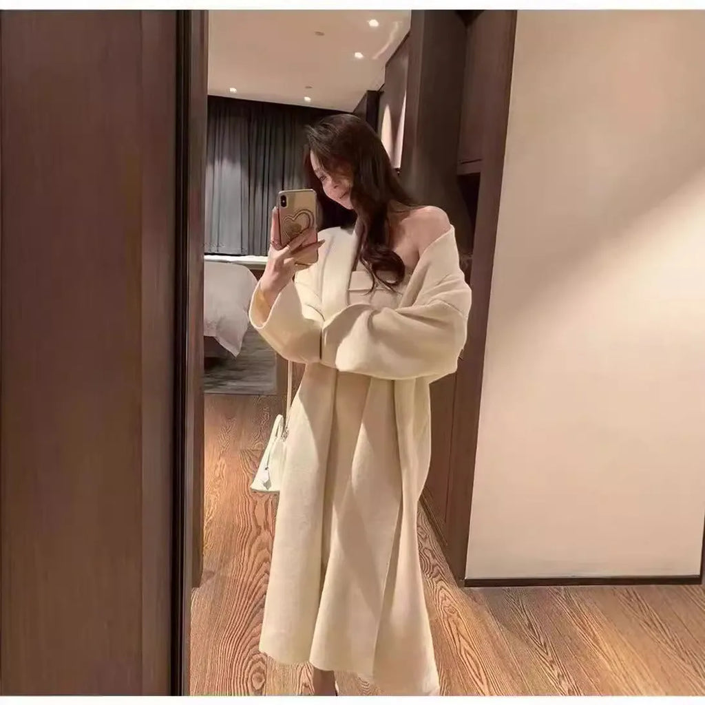 Women's gray knitted cardigan dress suit set with long skirt and regular sleeves.