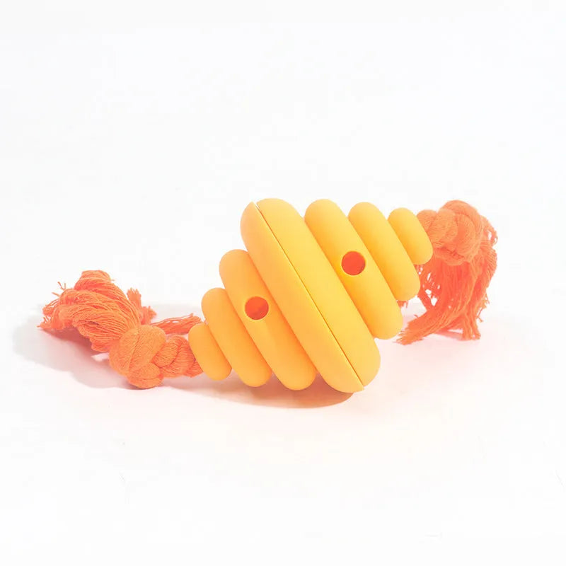 Green and yellow dog ball with rope toy showing split oval spiral design and integrated rope handle