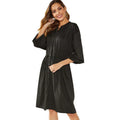 Women's black A-line dress with elastic waist, long sleeves, and a cinching belt on a mannequin.