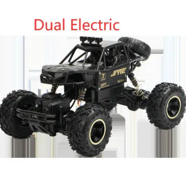Large black and silver 4WD remote control off-road climbing cars with wireless controller on a rocky surface.