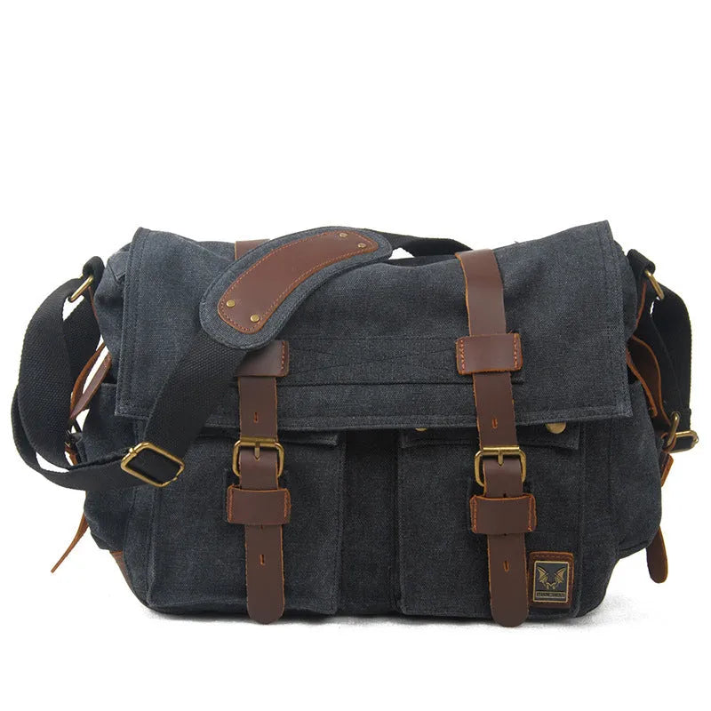 Men's brown canvas crossbody shoulder bag with leather trim shown open, revealing internal organiser pockets.