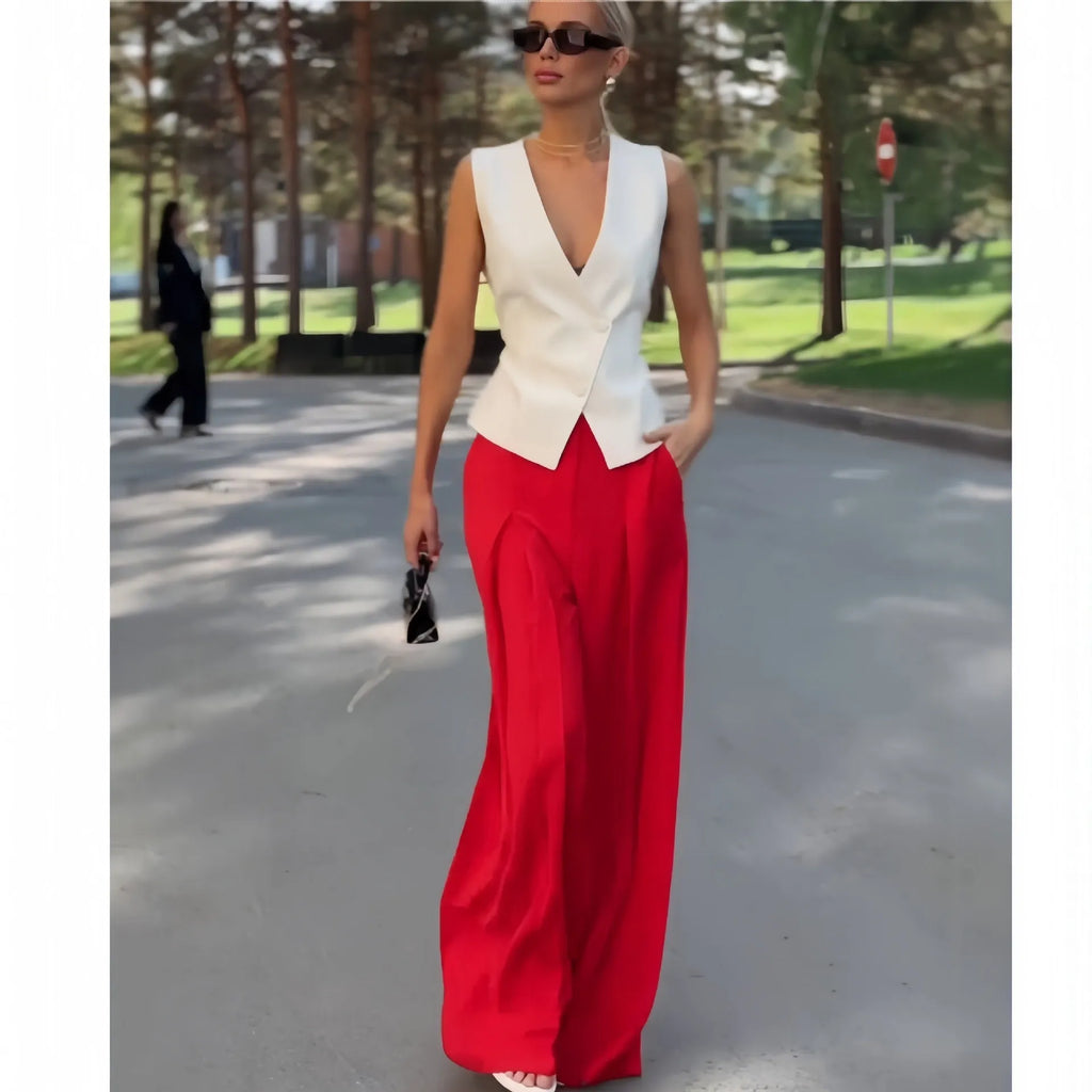 Women's beige two-piece set featuring a sleeveless deep V-neck top and high-waist wide-leg trousers.