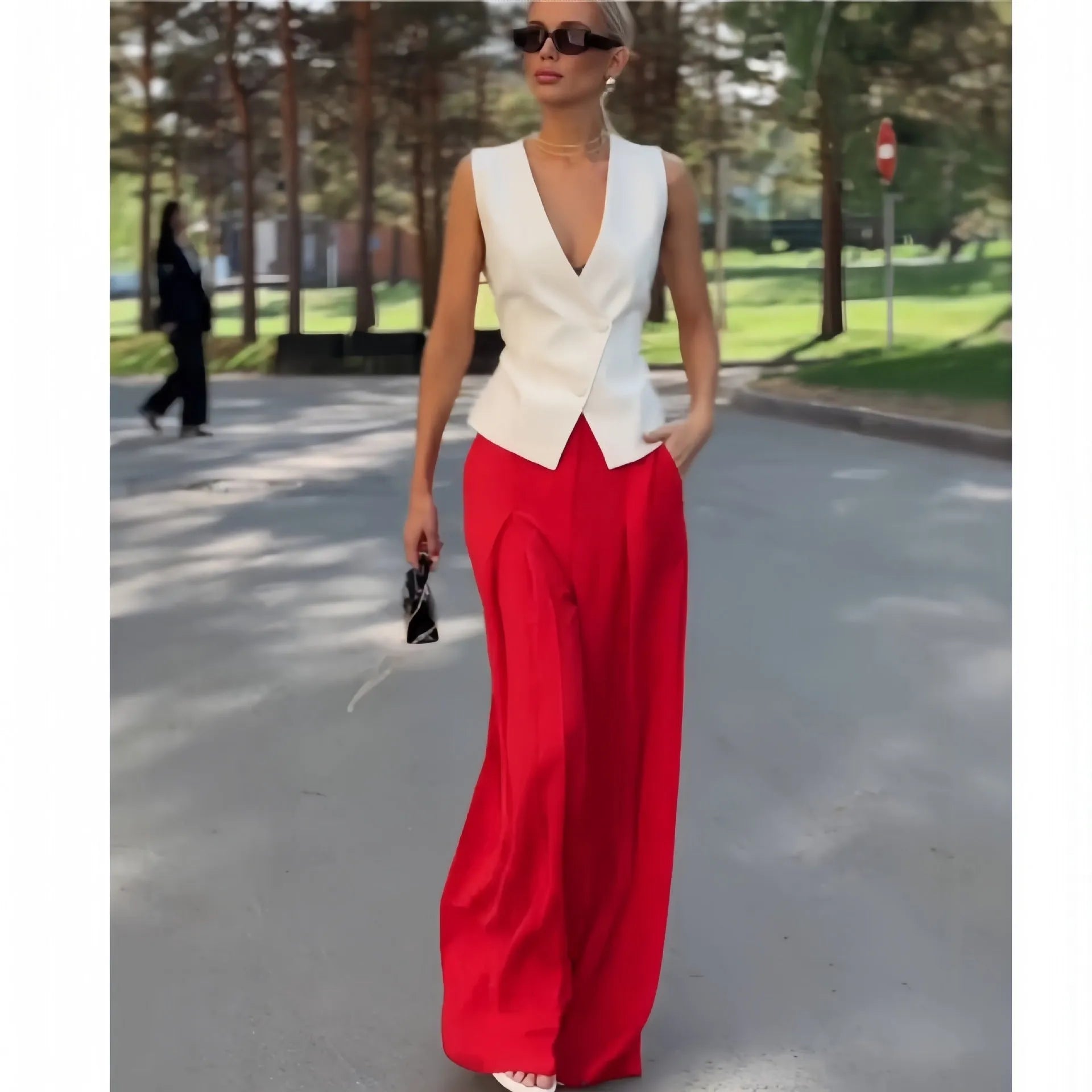 Women's beige two-piece set featuring a sleeveless deep V-neck top and high-waist wide-leg trousers.
