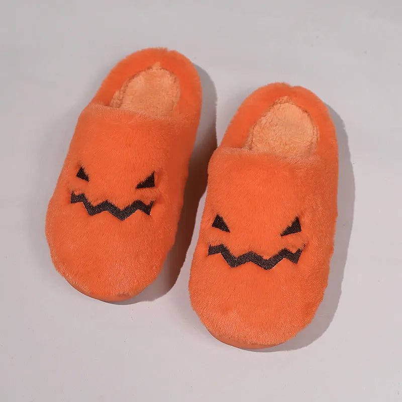 Orange Halloween pumpkin slippers with coral velvet upper and plush lining.