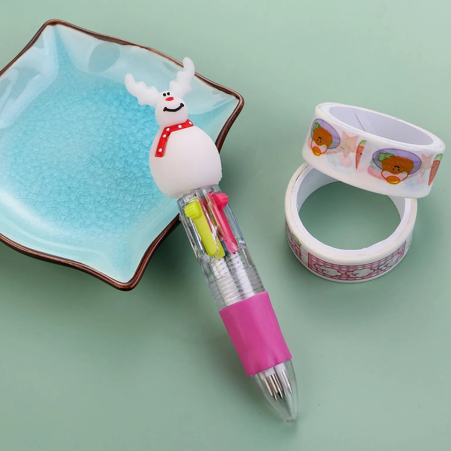 Christmas mini four-colour press-type ballpoint pen showing festive designs, 11cm long.