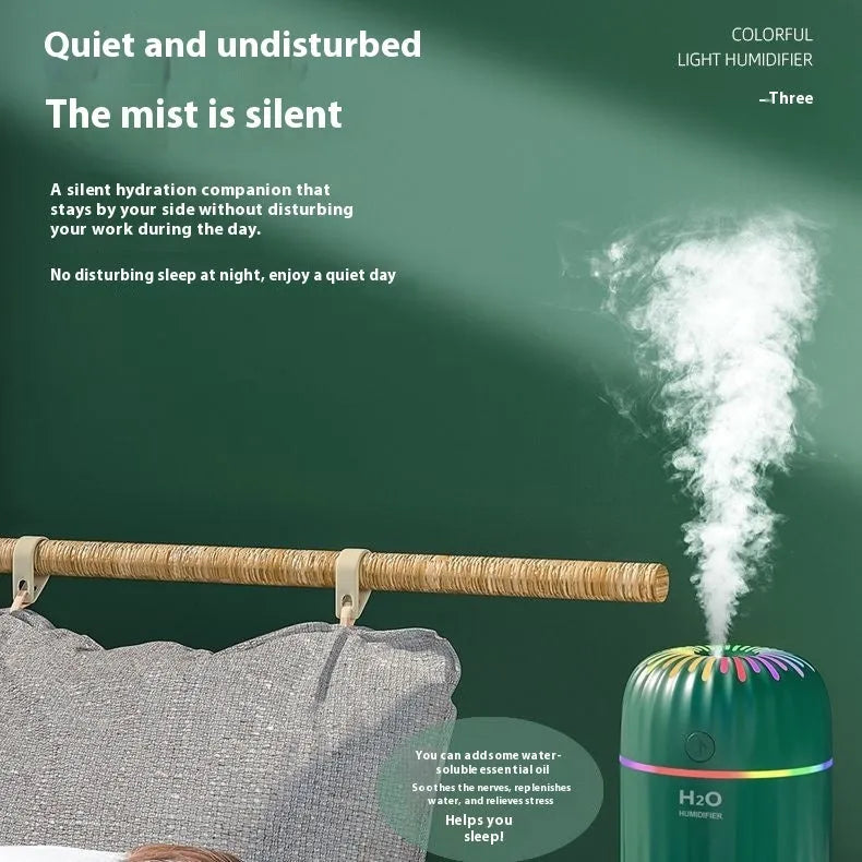 Mini USB-powered humidifier with animal design in green colour, showing compact size and data cable connection
