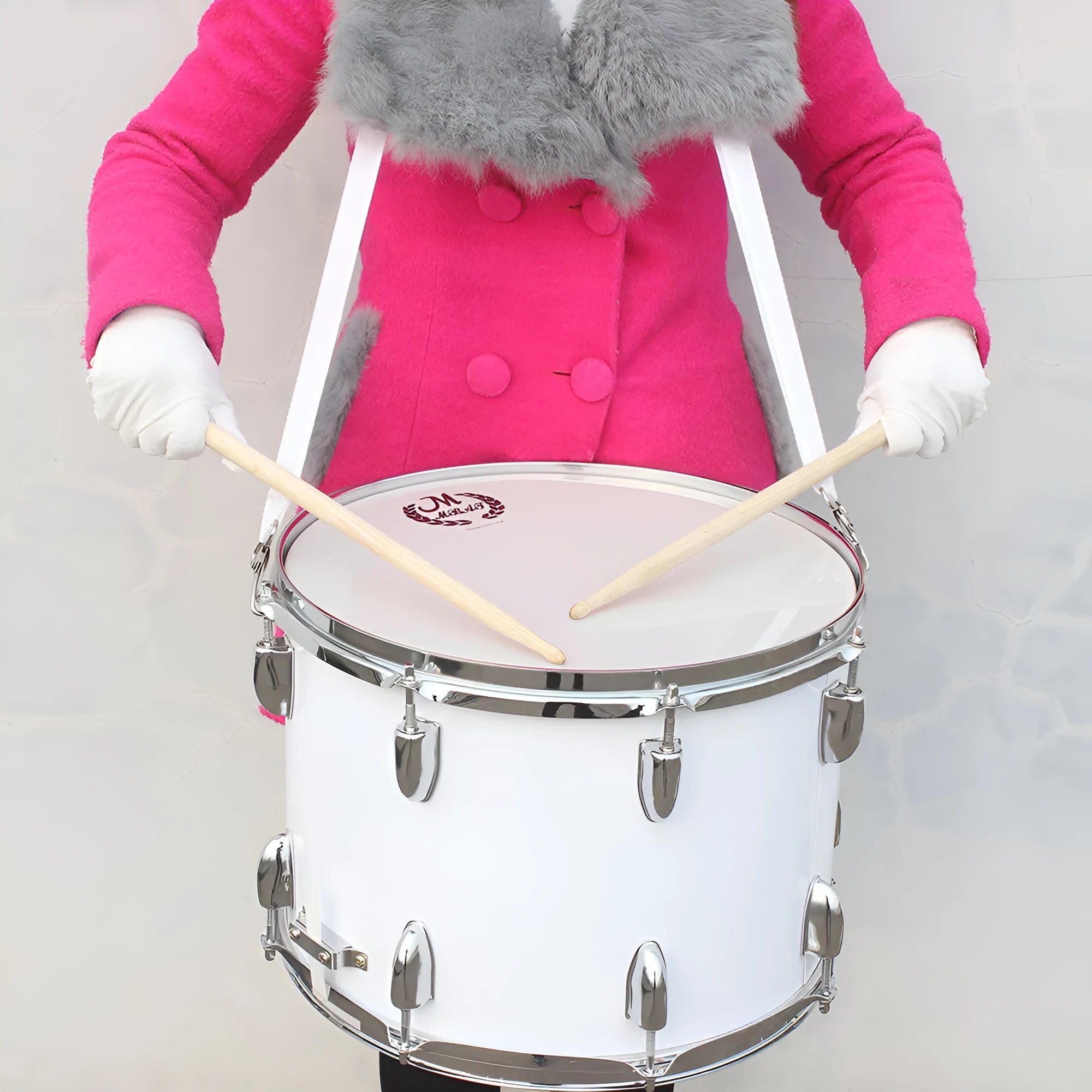 Mebet 14-inch white stainless steel snare drum with strap and drum stick on flat surface