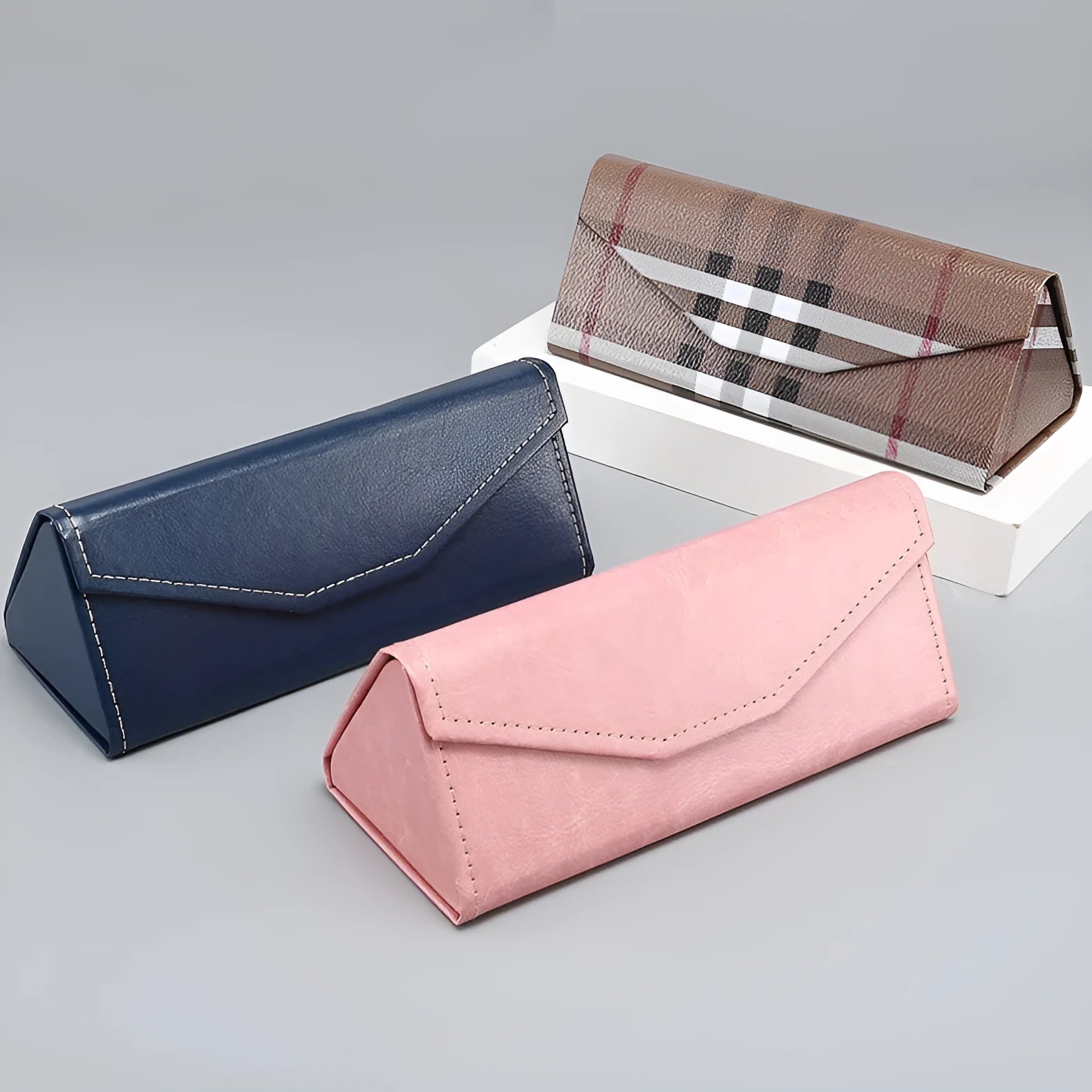 Triangular folding glasses case in various colours showing folded and open positions