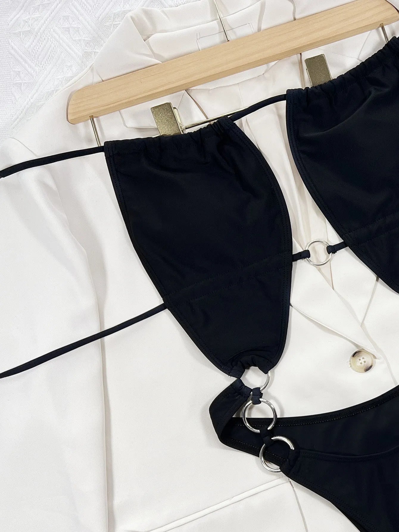 Black women's sleeveless one-piece swimsuit on hanger
