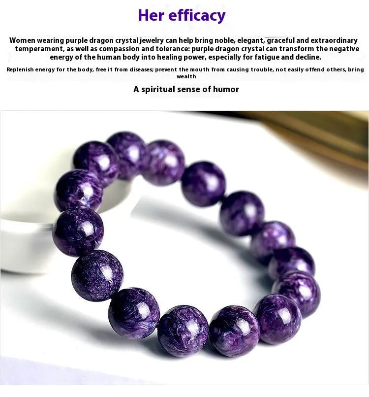 Natural transparent charoite crystal bead bracelet with platinum clasp on a wrist, showing violet and black swirled patterns.