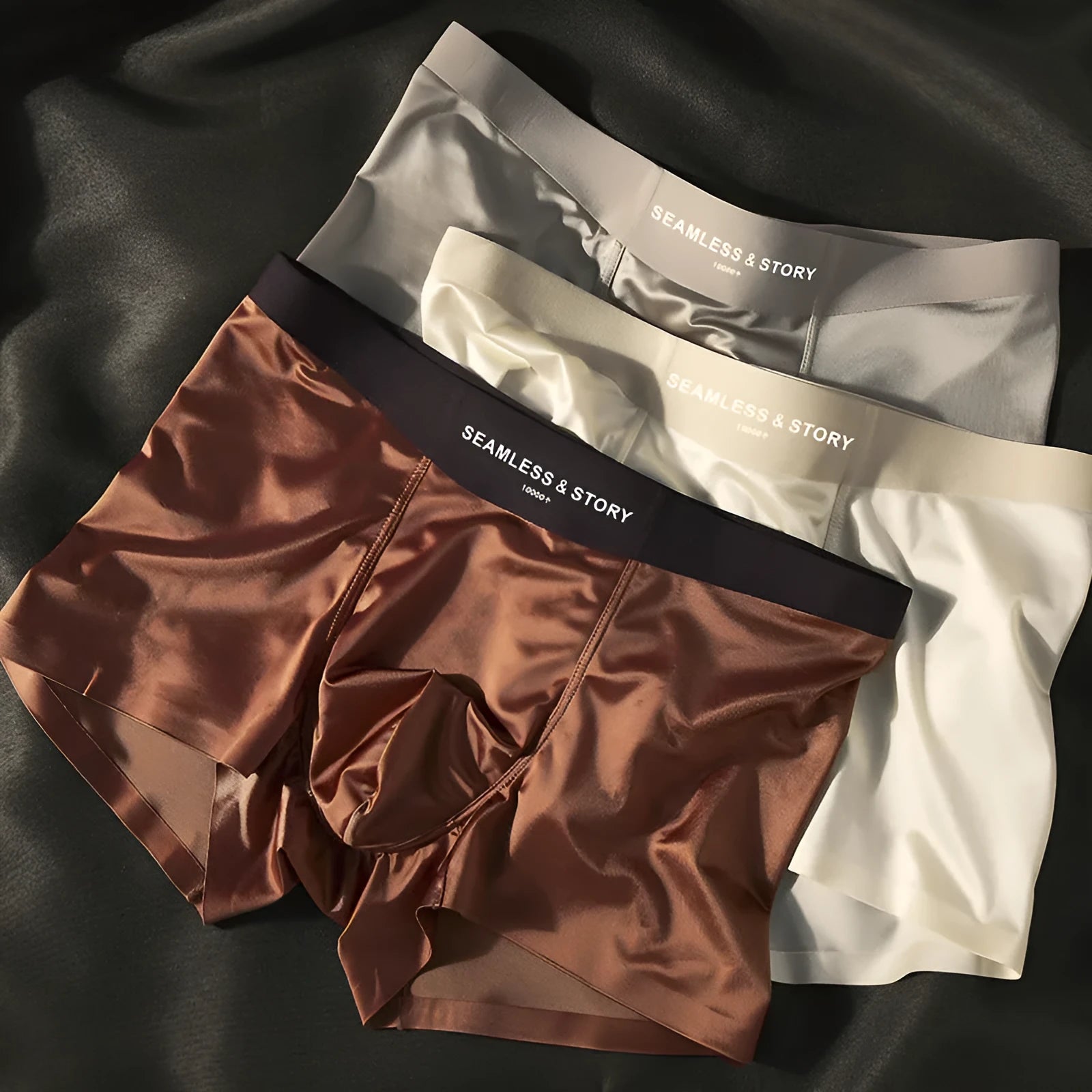 Men's solid colour ice silk briefs on a mid-waist mannequin, showing coffee, grey, white, and blue options.