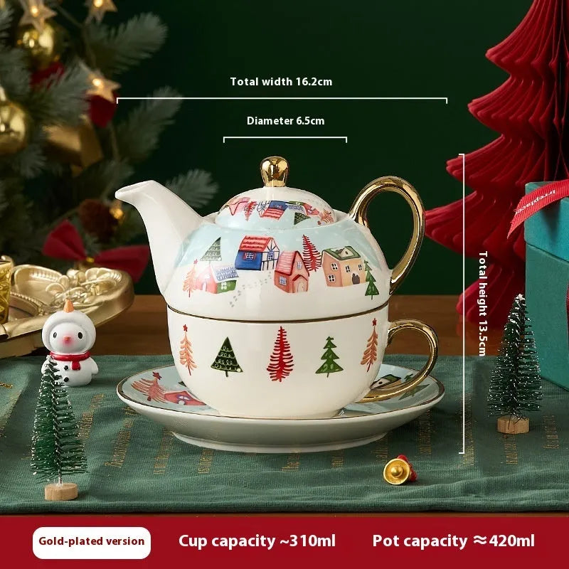 Ceramic gold-plated Christmas teapot set with snowflake design, including pot on dish and cup on dish with spoon, in gift box.