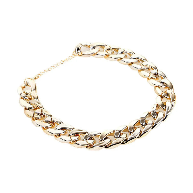 Geometric twisted chain dog collar with buckle on a white background, shown in a gold colour.