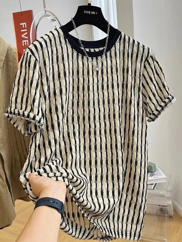 Black and white striped men's short sleeve loose fit pullover shirt on a hanger.