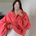 Women's watermelon red Mulberry Silk hooded sweater on a hanger, showing loose fit and front design.