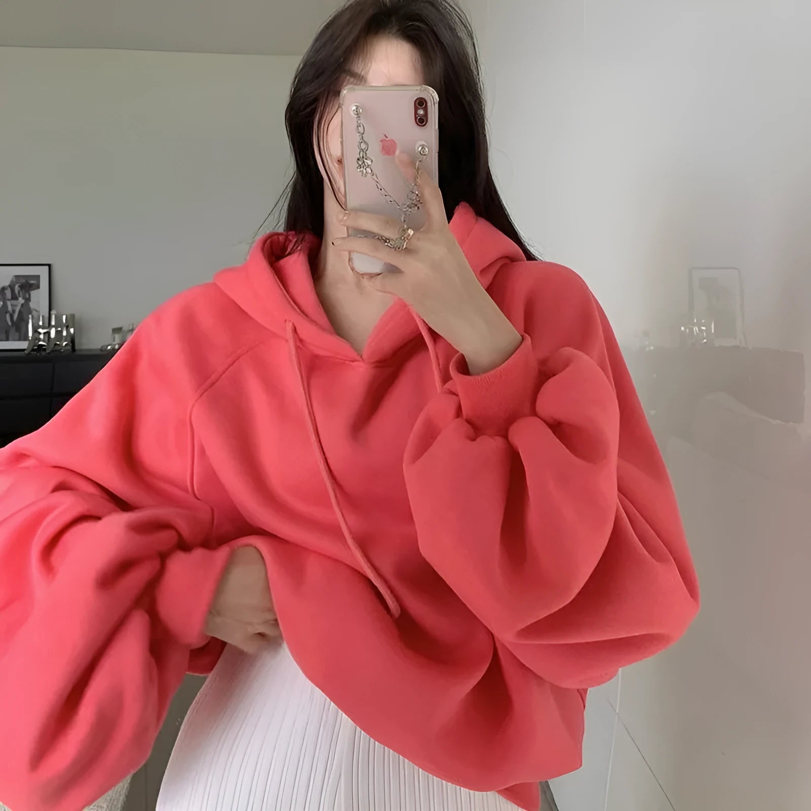 Women's watermelon red Mulberry Silk hooded sweater on a hanger, showing loose fit and front design.
