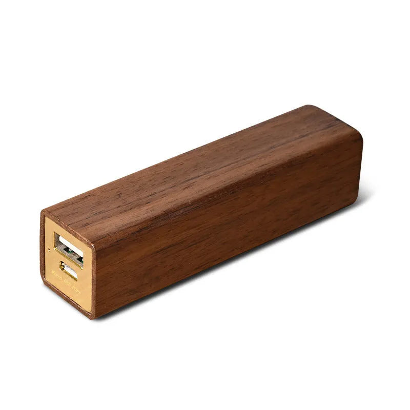 Black walnut wood portable power bank showing natural grain, with dimensions 100mm by 25mm.