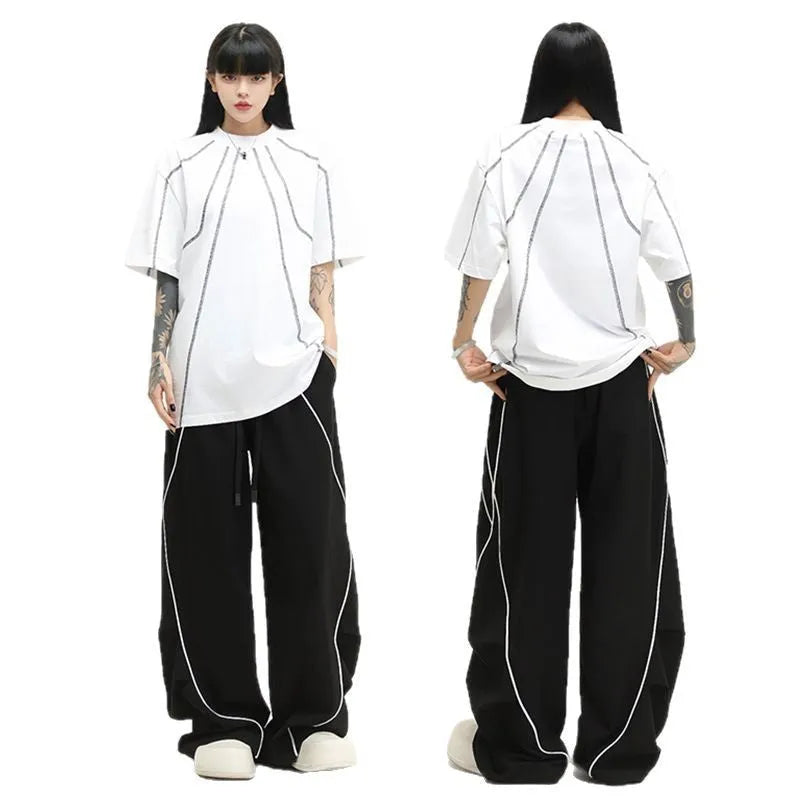 Black pleated wide-leg hip hop trousers with a striped pattern on a mid waist.