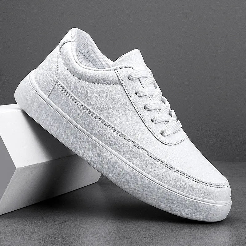 Women's white leather flat casual shoes with lace-up front on a plain background