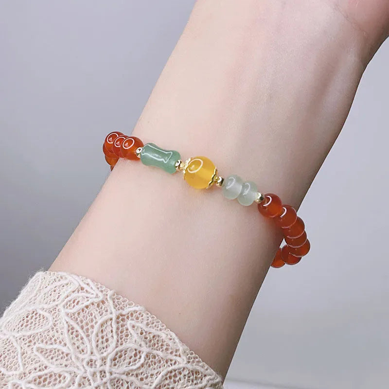 Handcrafted red agate bracelet with Chinese Dragon and Lucky Bag festival motifs