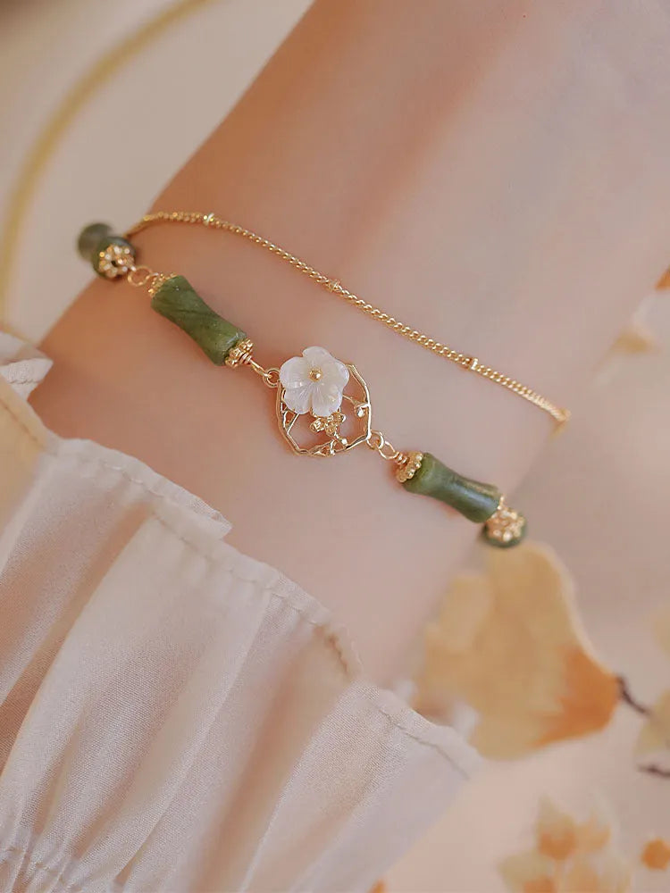 Natural green olivine bracelet with double layer design and Bells of Ireland charms