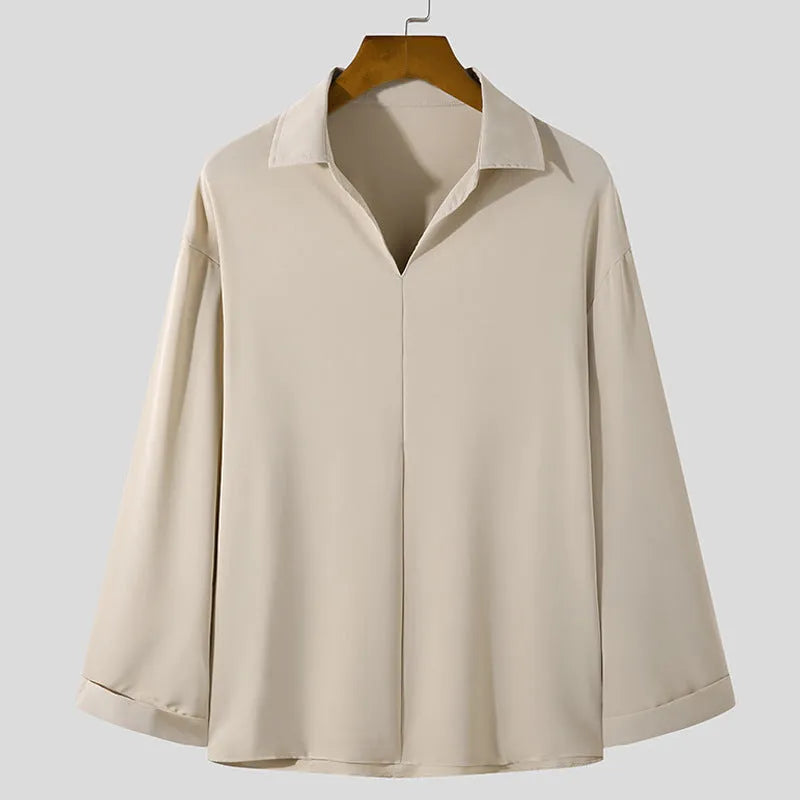 Men's loose lapel long sleeve shirt in a solid colour on a hanger.