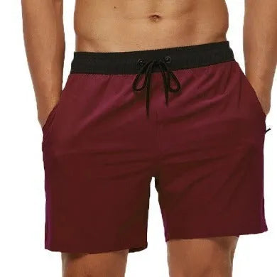 Men's blue athletic shorts with stitching waist detail, drawstring, zipper, and side pockets.