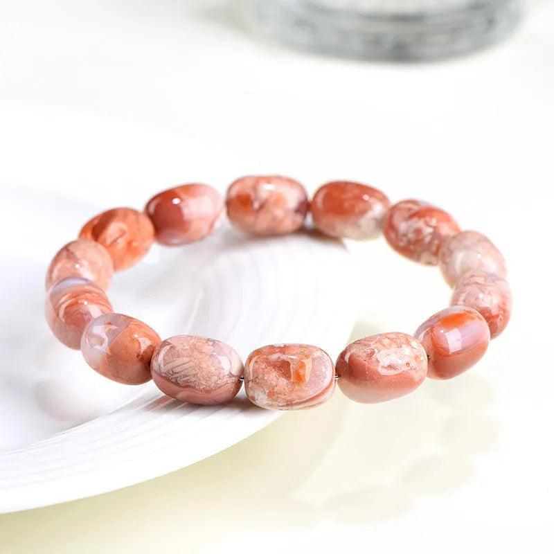 Natural cherry agate bracelet with barrel shaped beads and carved Ruyi symbols