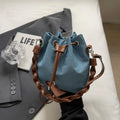 Blue synthetic leather cross body bucket bag with sandwich pocket and sling strap