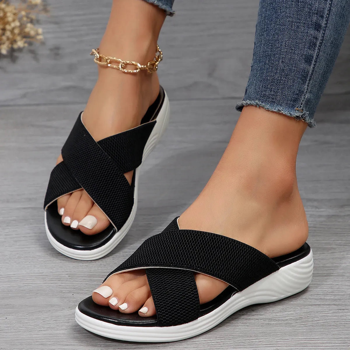 Women's black wedge slippers with cross-strap peep-toe design and thick rubber sole
