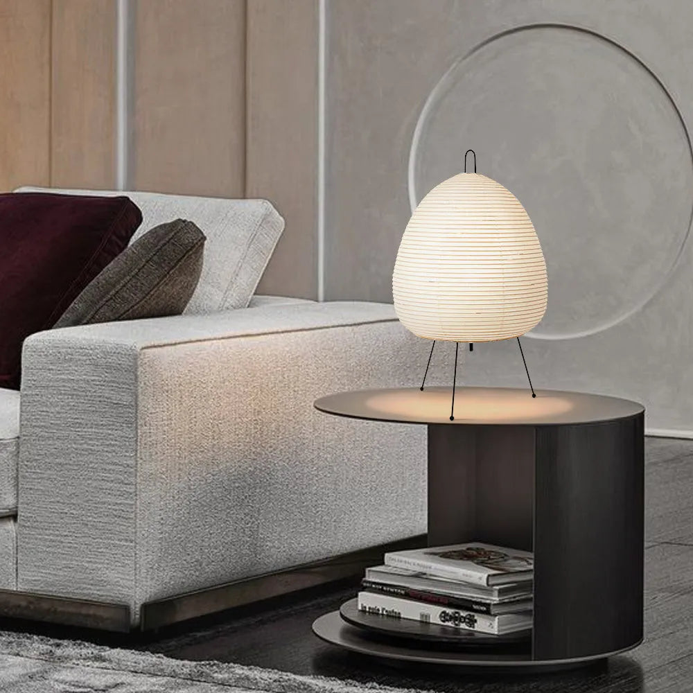 Japanese-style paper table lamp with handmade shade and aluminium base on wooden surface
