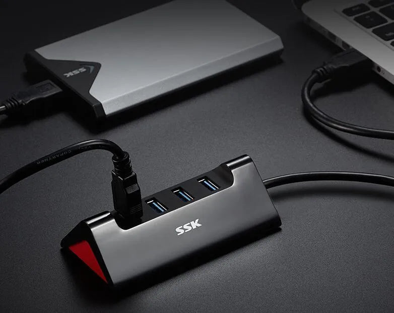 Black ABS plastic USB expansion dock with four ports showing Micro USB power connection