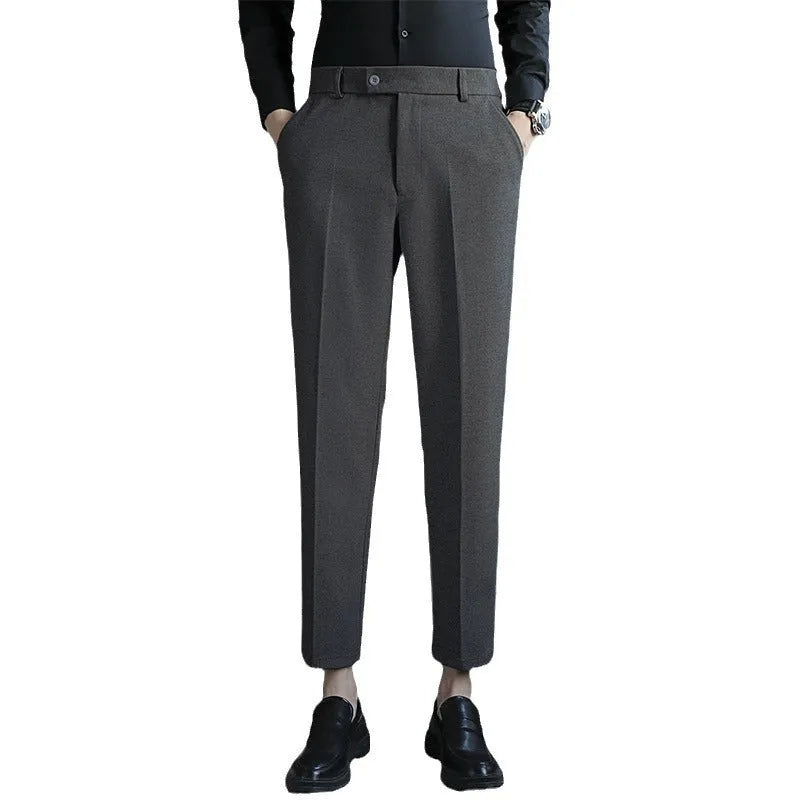 Straight-leg brown corduroy trousers with an elasticated waistband laid flat.