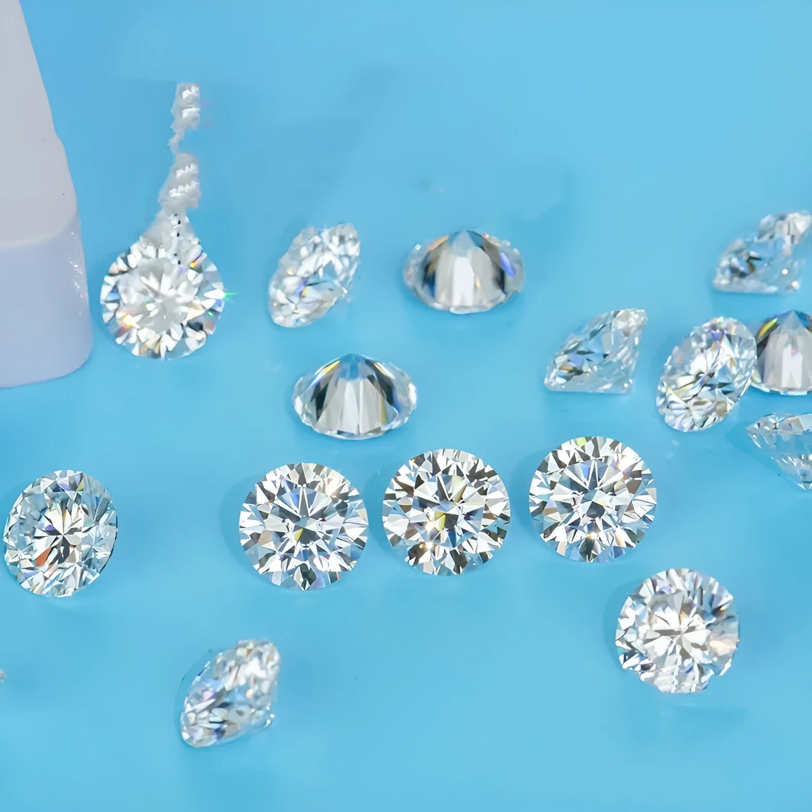 Round moissanite gemstone with eight hearts and eight arrows cut on a grey background.
