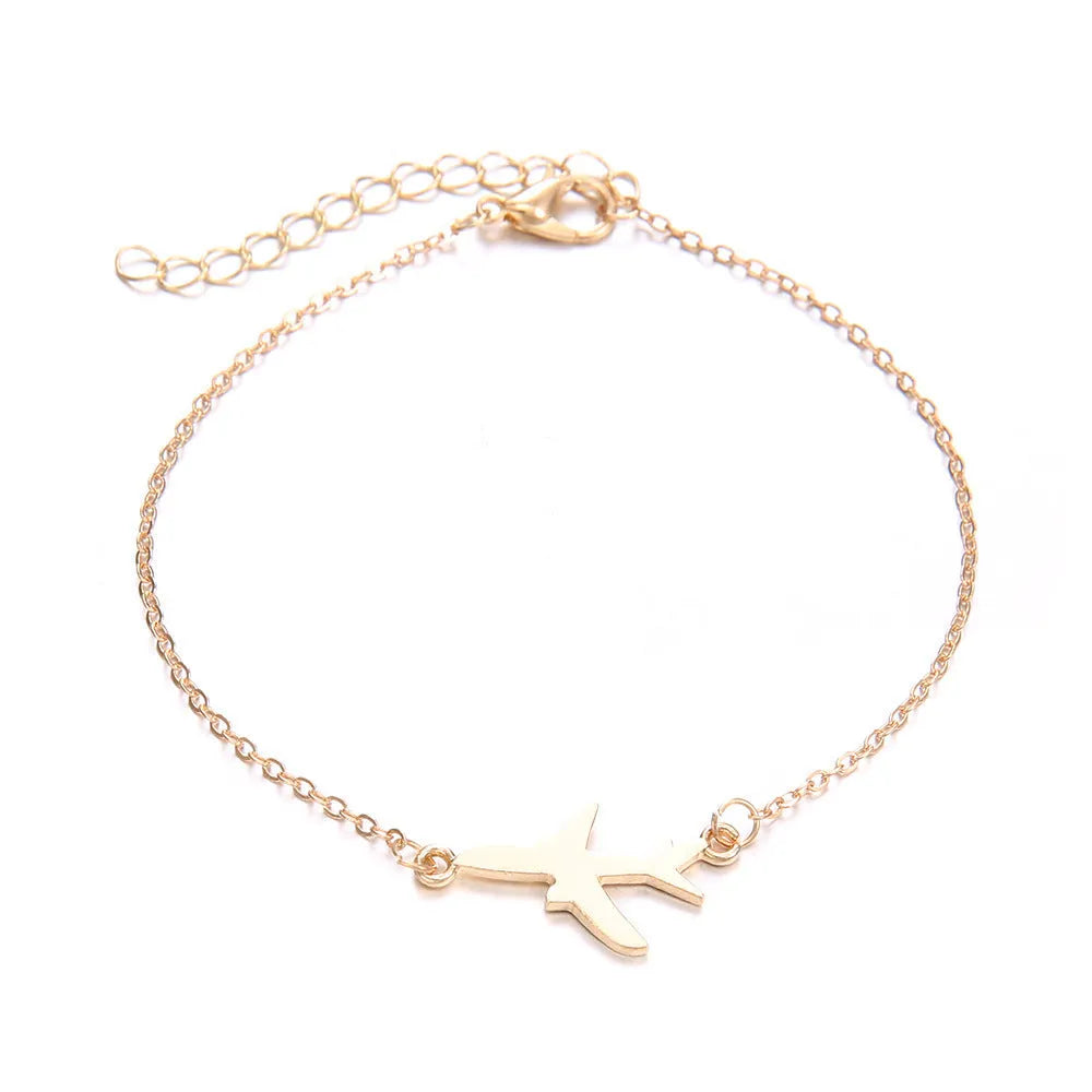 Three bohemian-style bracelets with heart-shaped aircraft map charms in electroplated alloy